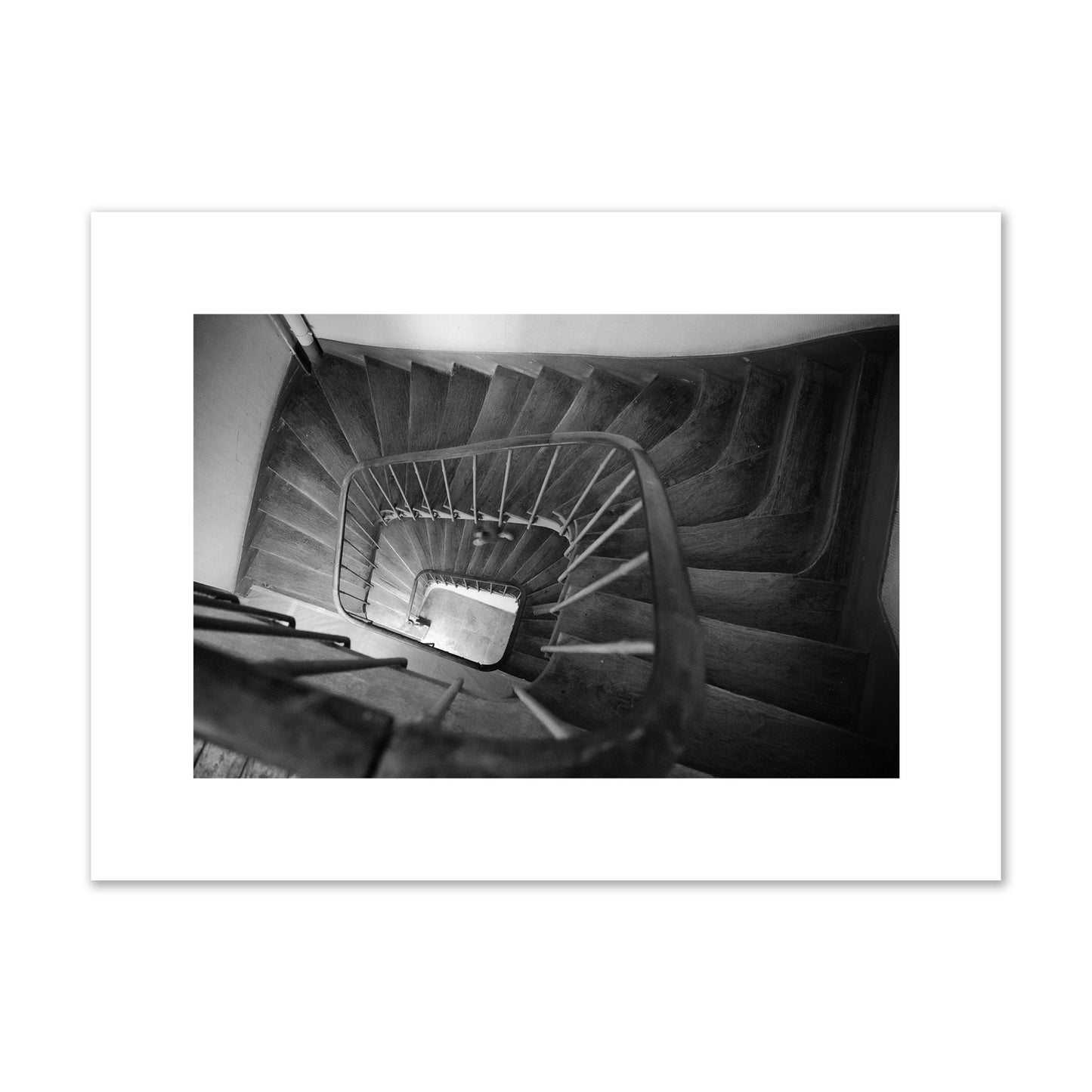 Fine art street photograph of a person walking down a staircase in Paris, France, archival pigment print, medium size, unframed