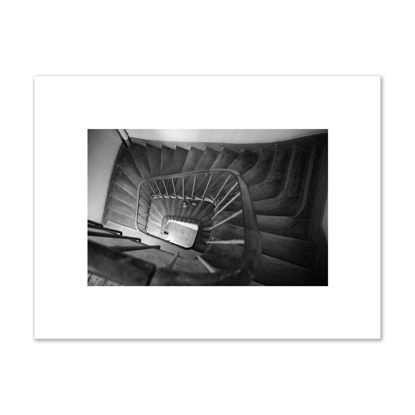 Fine art street photograph of a person walking down a staircase in Paris, France, archival pigment print, small size, unframed