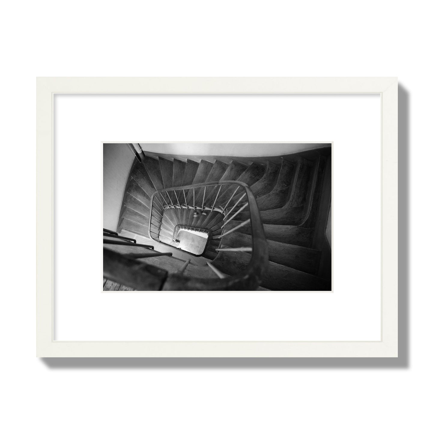 Fine art street photograph of a person walking down a staircase in Paris, France, archival pigment print, small size, white frame