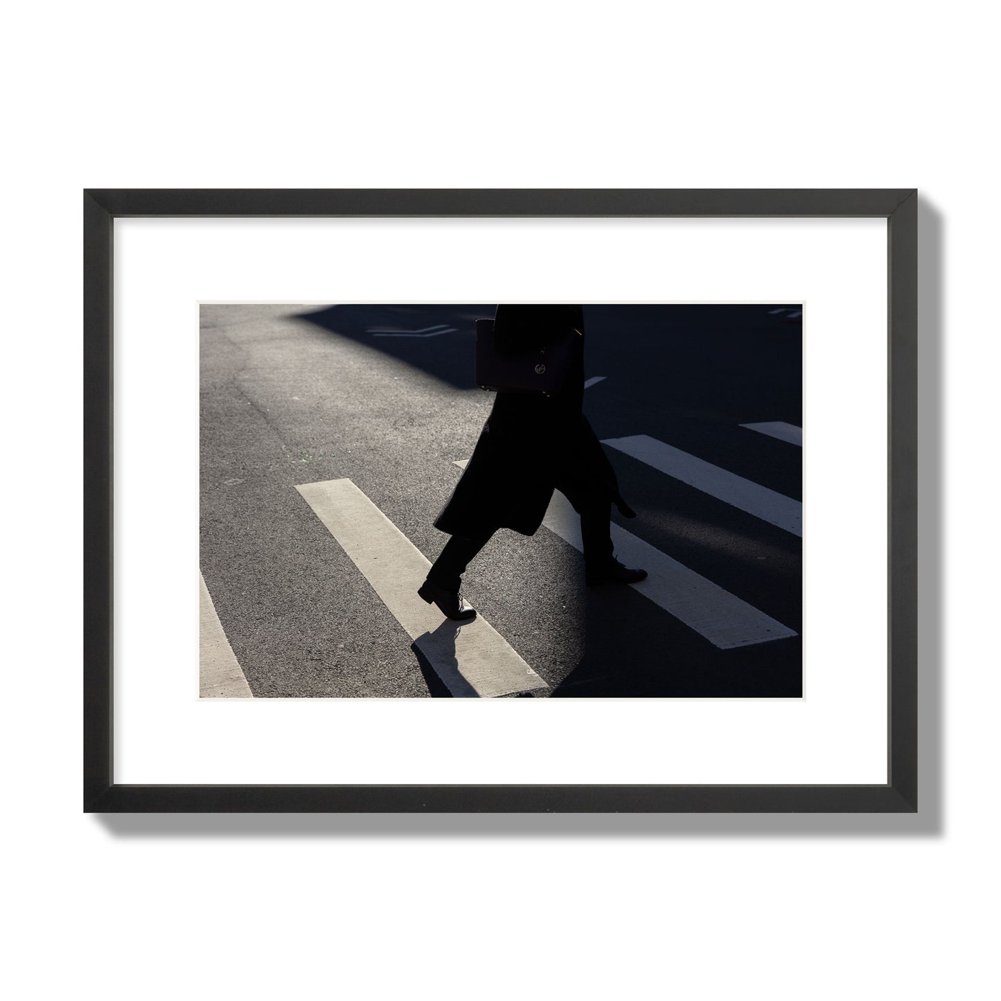 Fine art street photograph of a woman walking through a crosswalk in Soho New York, archival pigment print, medium size, black frame