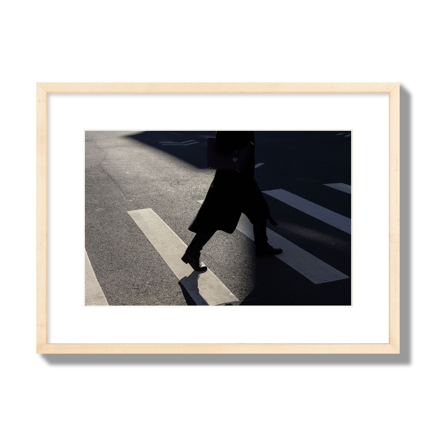 Fine art street photograph of a woman walking through a crosswalk in Soho New York, archival pigment print, medium size, natural wood frame