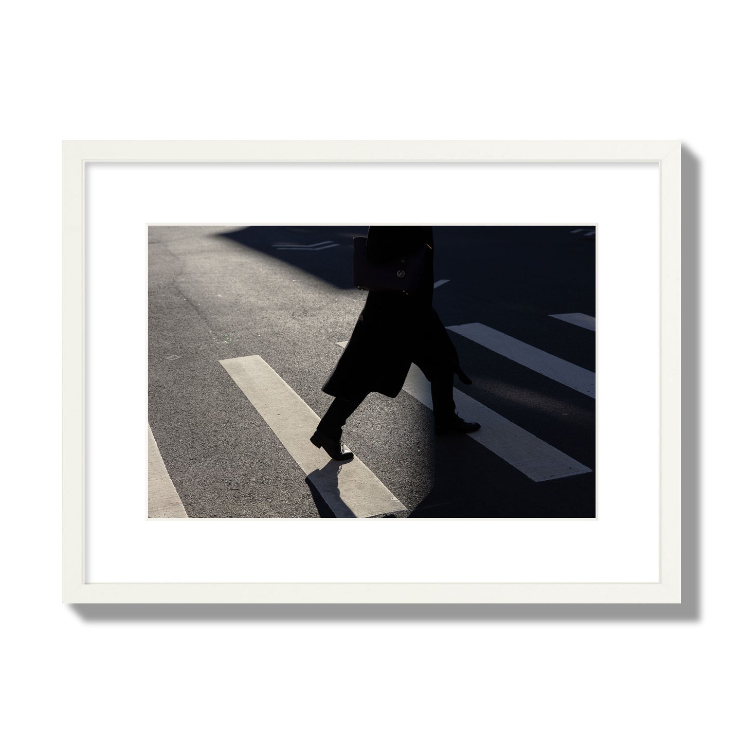 Fine art street photograph of a woman walking through a crosswalk in Soho New York, archival pigment print, medium size, white frame