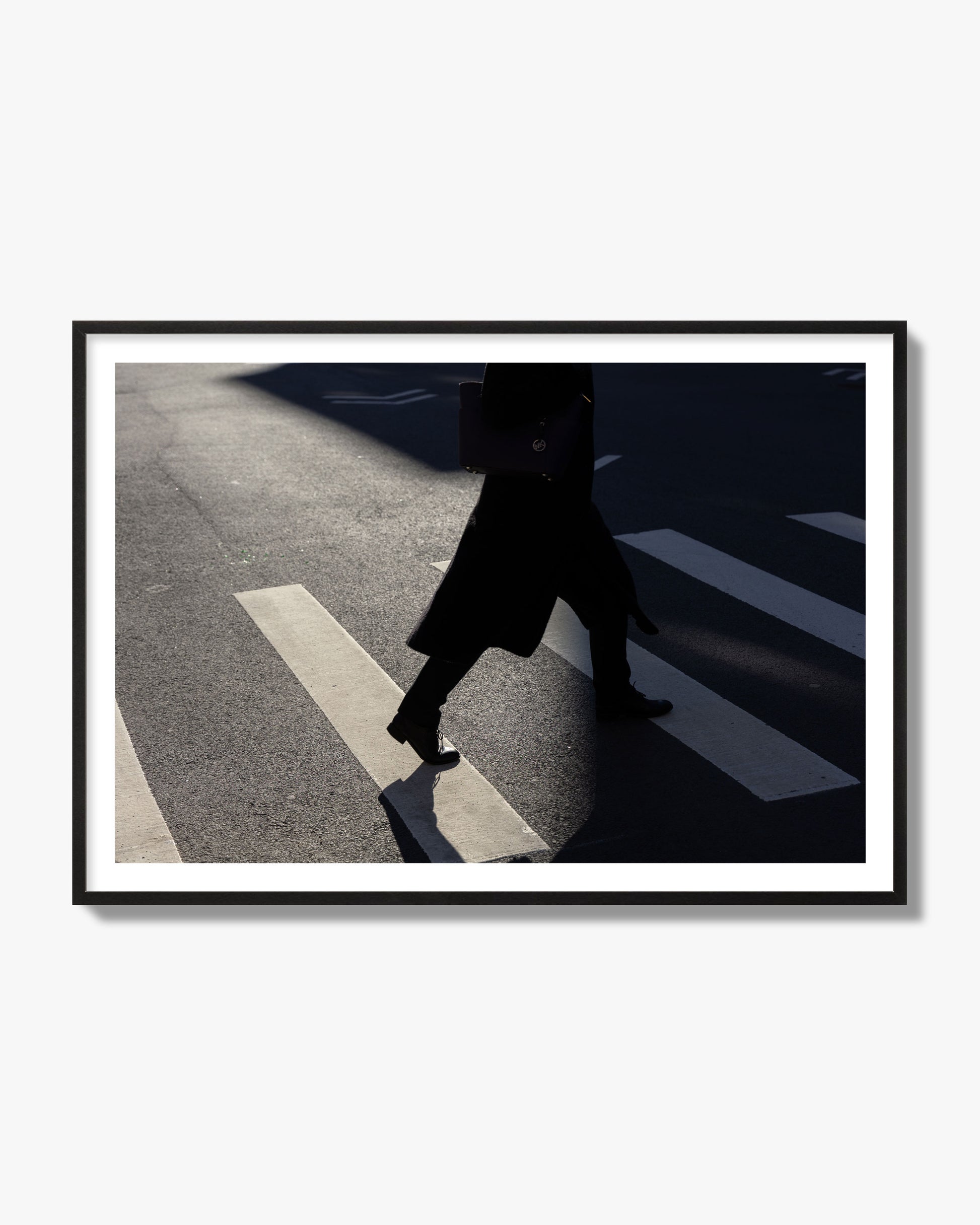 Fine art street photograph of a woman walking through a crosswalk in Soho New York, archival pigment print, black frame