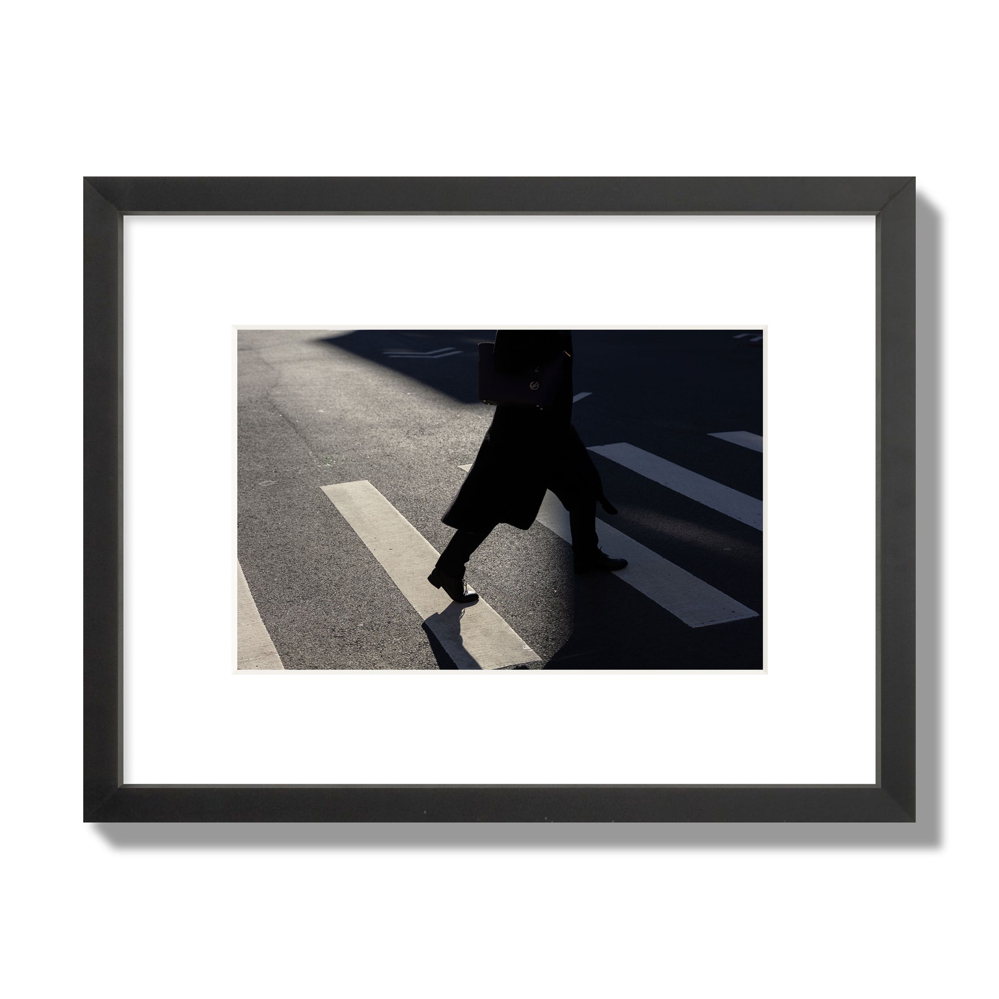 Fine art street photograph of a woman walking through a crosswalk in Soho New York, archival pigment print, small size, black frame