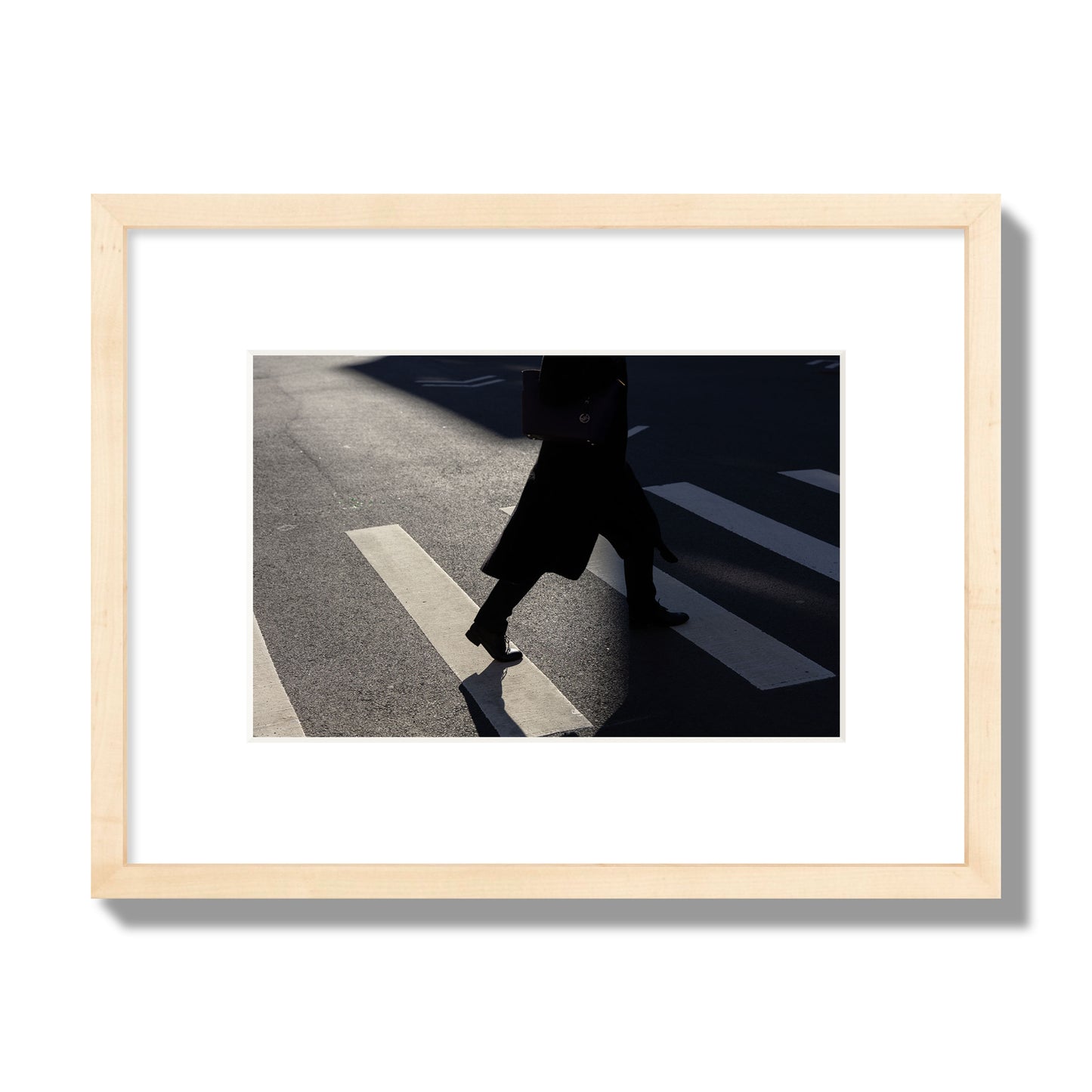 Fine art street photograph of a woman walking through a crosswalk in Soho New York, archival pigment print, small size, natural wood frame