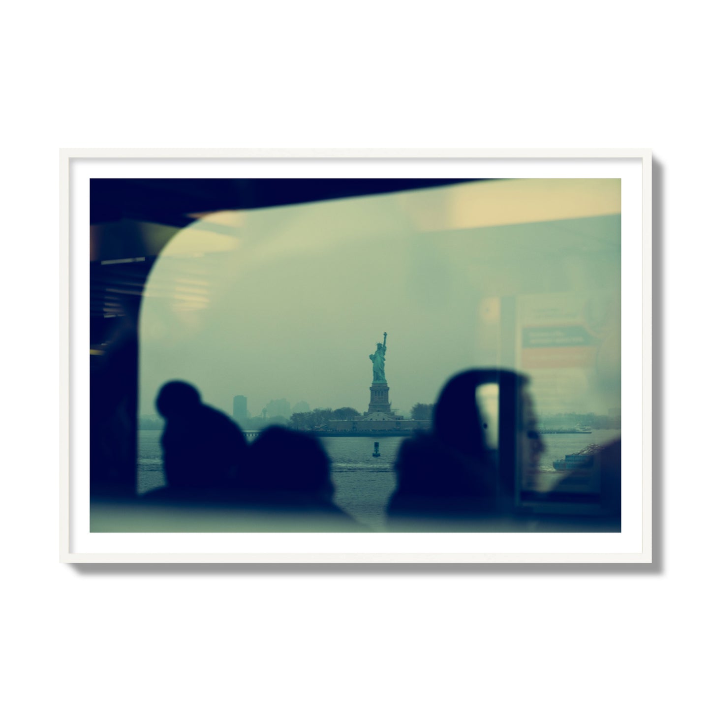 Fine art photograph of passengers silhouetted on a crowded ferry with the Statue of Liberty in the background, archival pigment print, collector size, white frame.
