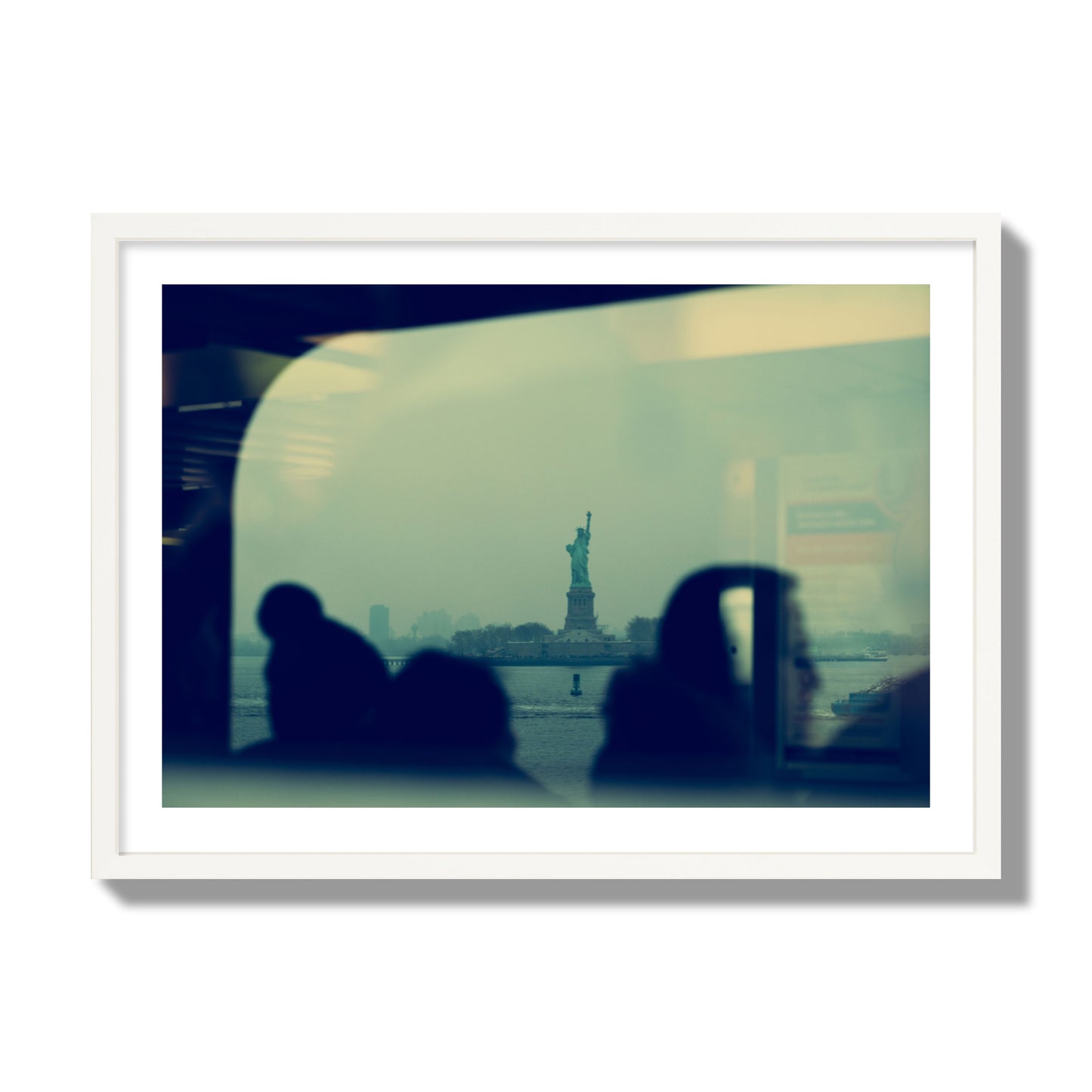 Fine art photograph of passengers silhouetted on a crowded ferry with the Statue of Liberty in the background, archival pigment print, giant size, white frame.