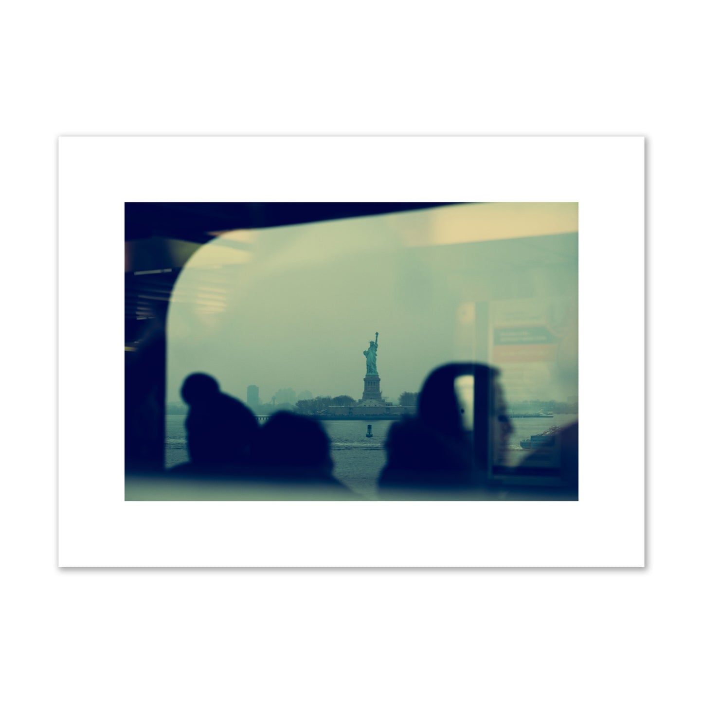 Fine art photograph of passengers silhouetted on a crowded ferry with the Statue of Liberty in the background, archival pigment print, medium size, unframed.