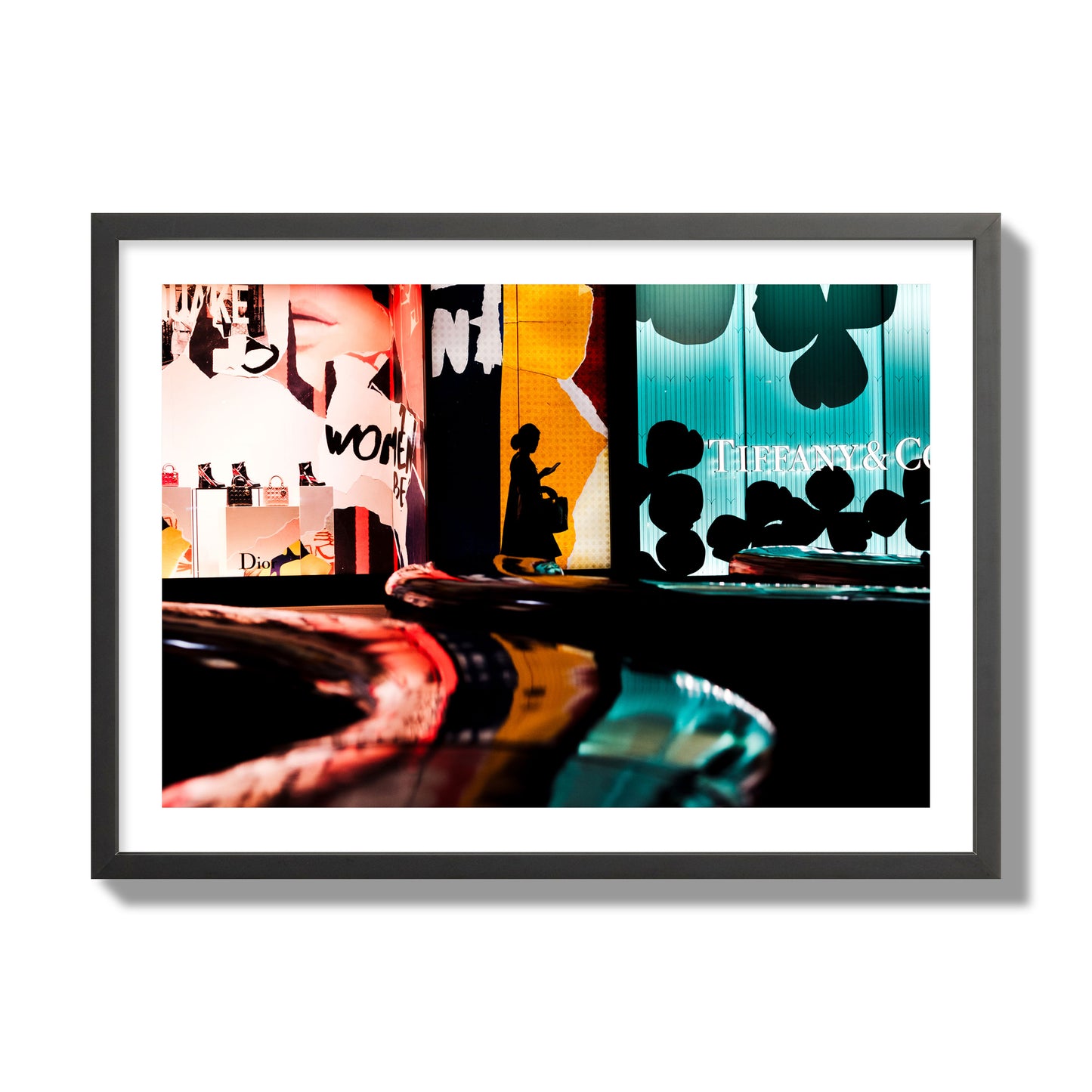 Fine art photograph of a woman’s silhouette walking past vibrant neon store signs, archival pigment print, giant size, black frame.