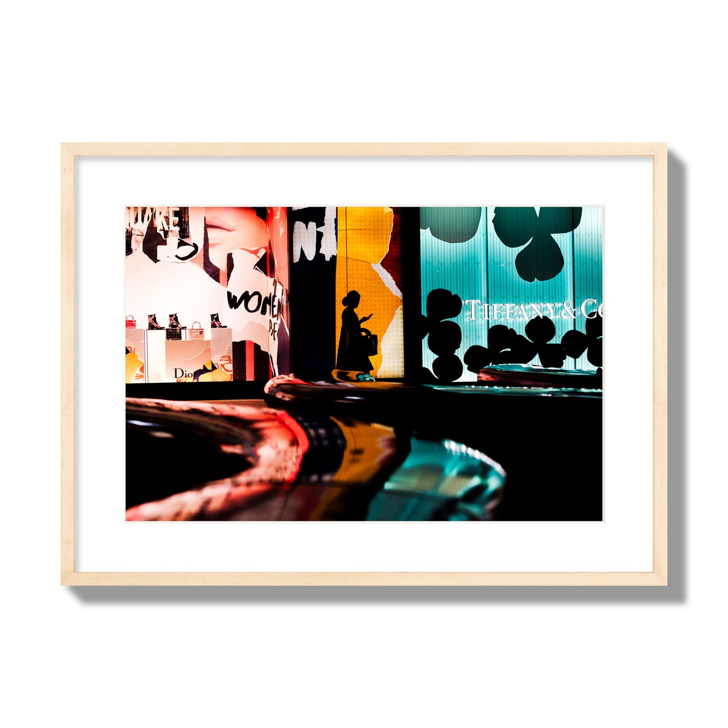 Fine art photograph of a woman’s silhouette walking past vibrant neon store signs, archival pigment print, large size, natural wood frame.
