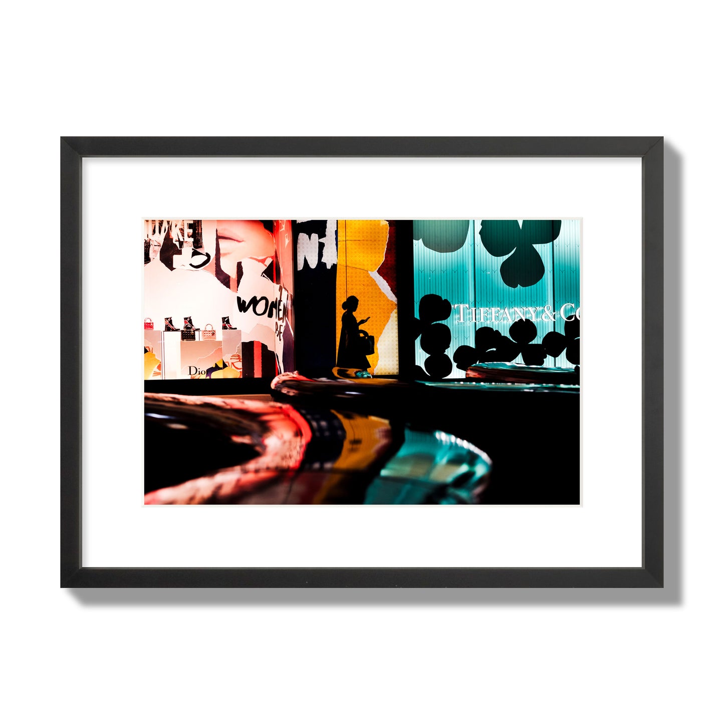 Fine art photograph of a woman’s silhouette walking past vibrant neon store signs, archival pigment print, medium size, black frame.
