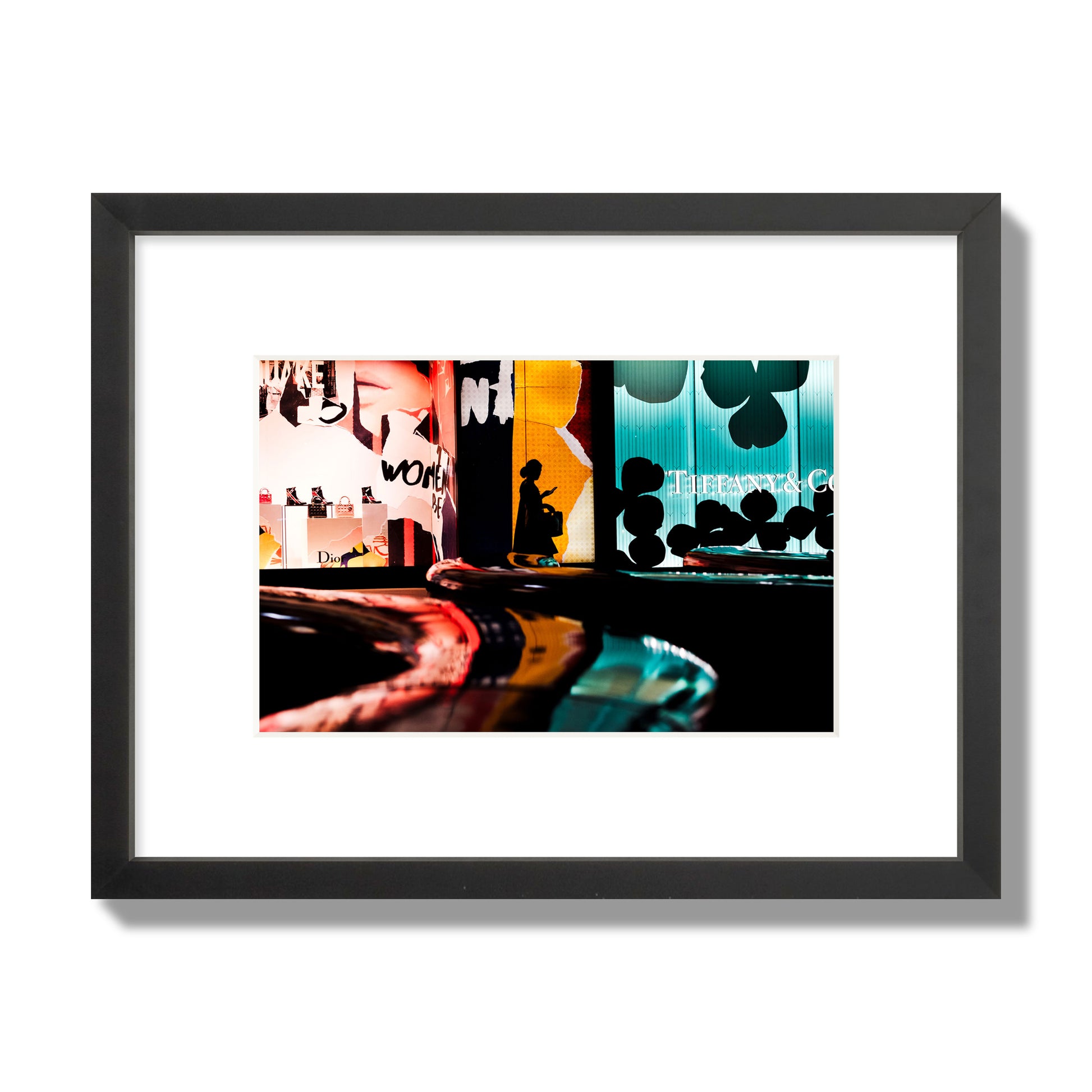 Fine art photograph of a woman’s silhouette walking past vibrant neon store signs, archival pigment print, small size, black frame.