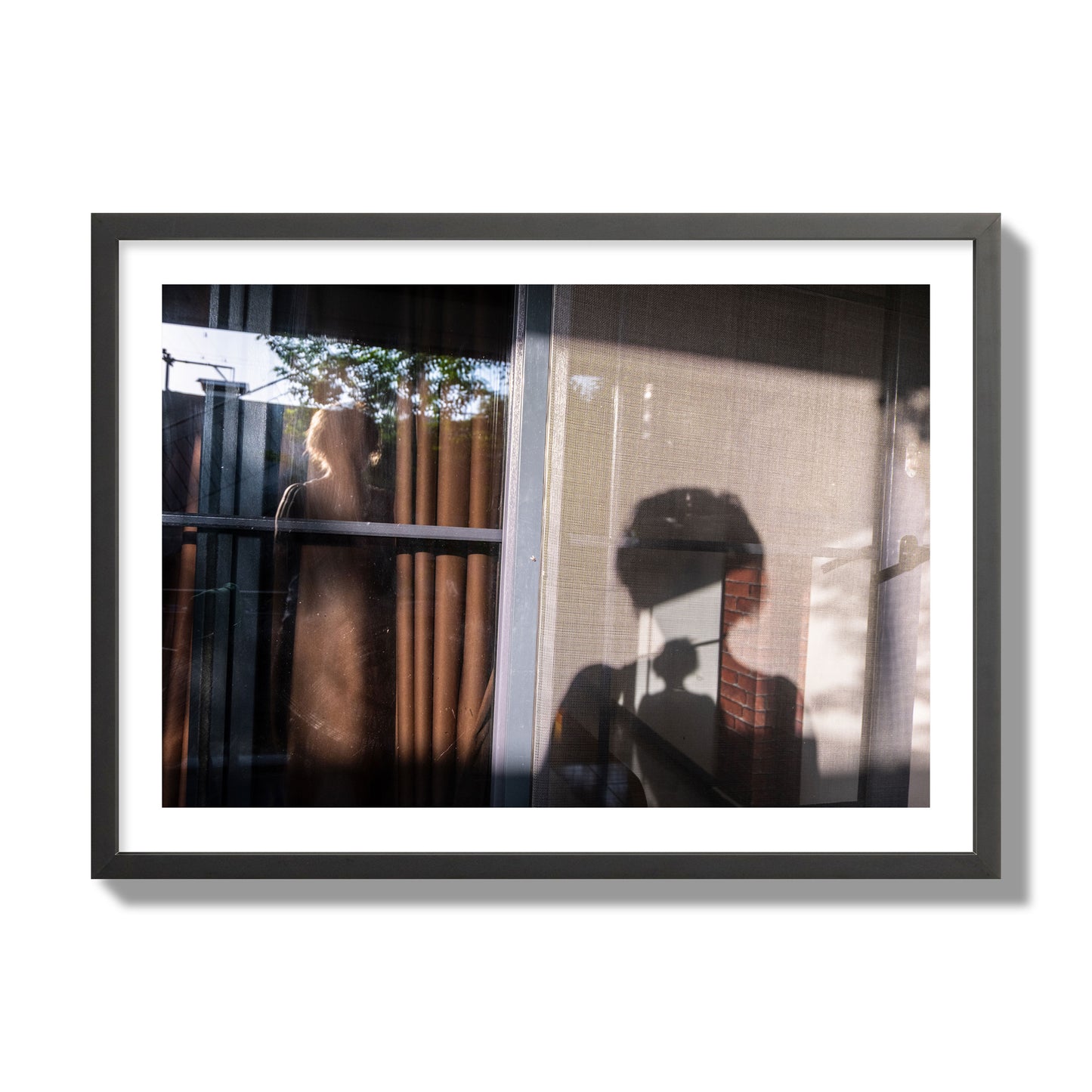 Fine art photograph of a person's silhouette against a window with curtains, archival pigment print, giant size, black frame.