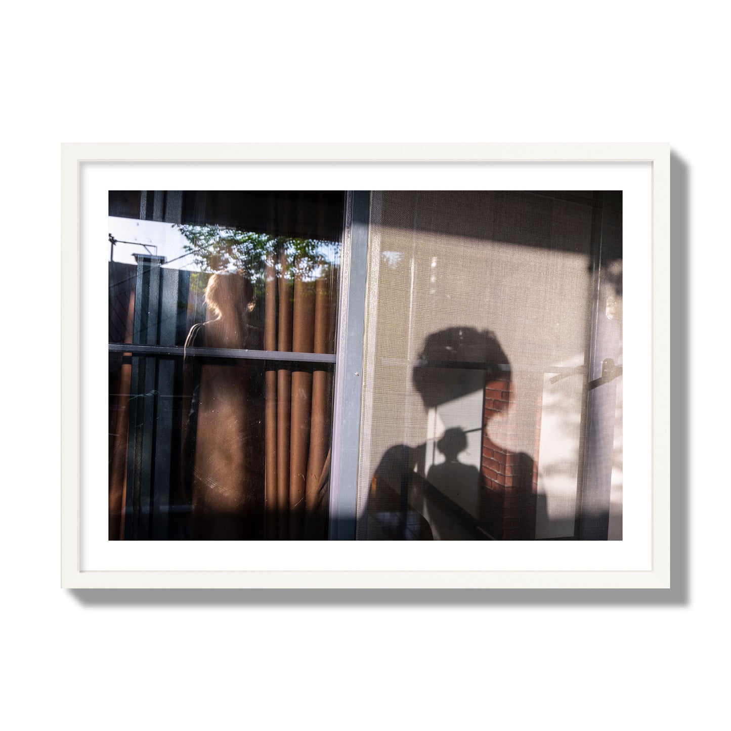 Fine art photograph of a person's silhouette against a window with curtains, archival pigment print, giant size, white frame.