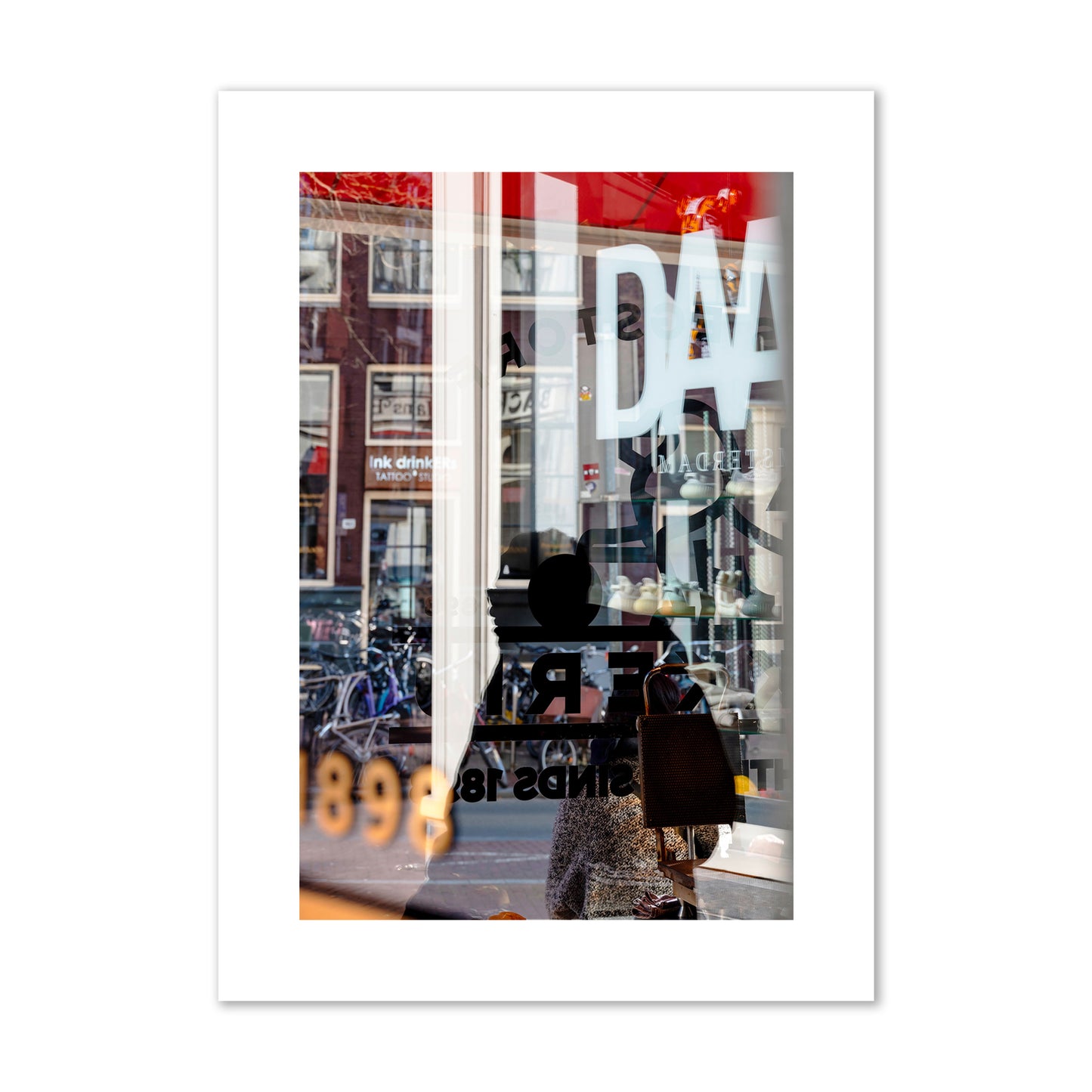 Fine art street photograph of a busy Amsterdam street scene with reflections, silhouettes, shoppers, and store signs. Archival pigment print, large size, unframed.