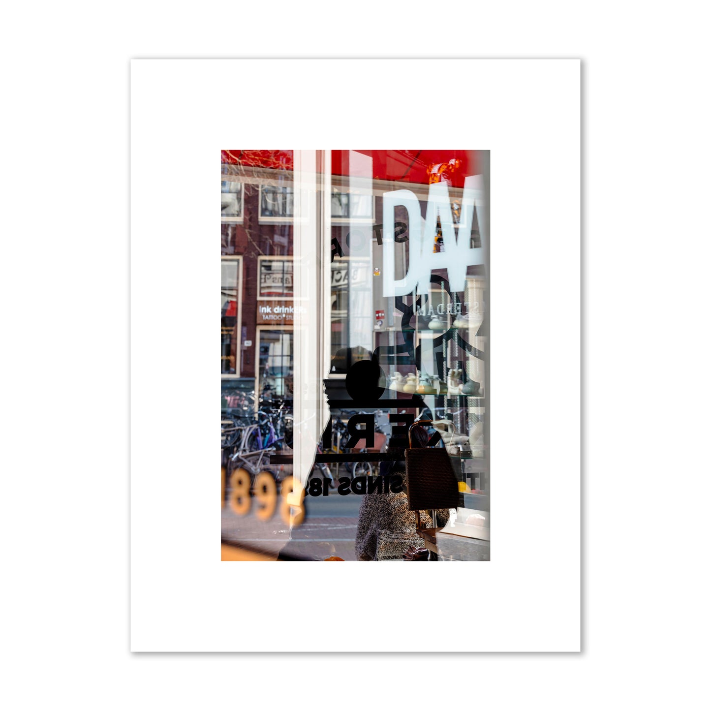 Fine art street photograph of a busy Amsterdam street scene with reflections, silhouettes, shoppers, and store signs. Archival pigment print, small size, unframed.