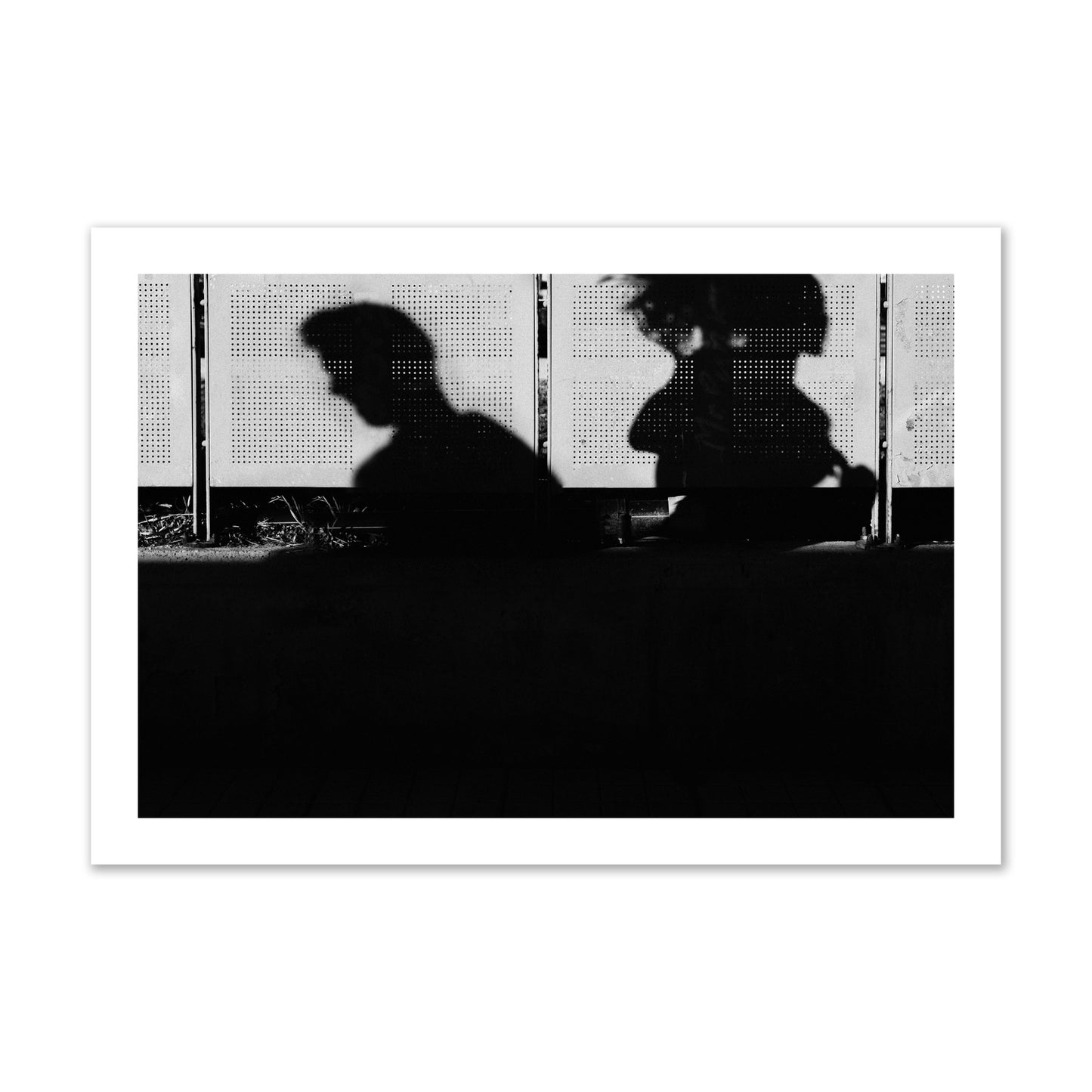 Fine art black and white street photography capturing the silhouettes of two individuals against a wall in Athens Greece, archival pigment print, collector size, unframed