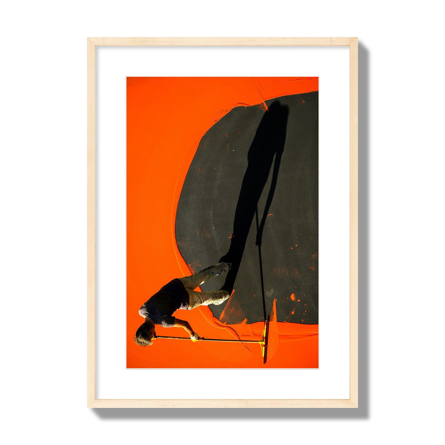 Fine art street photograph, overhead view of a man painting an orange rooftop, captured in vivid detail. Archival pigment print, large size, natural wood frame.