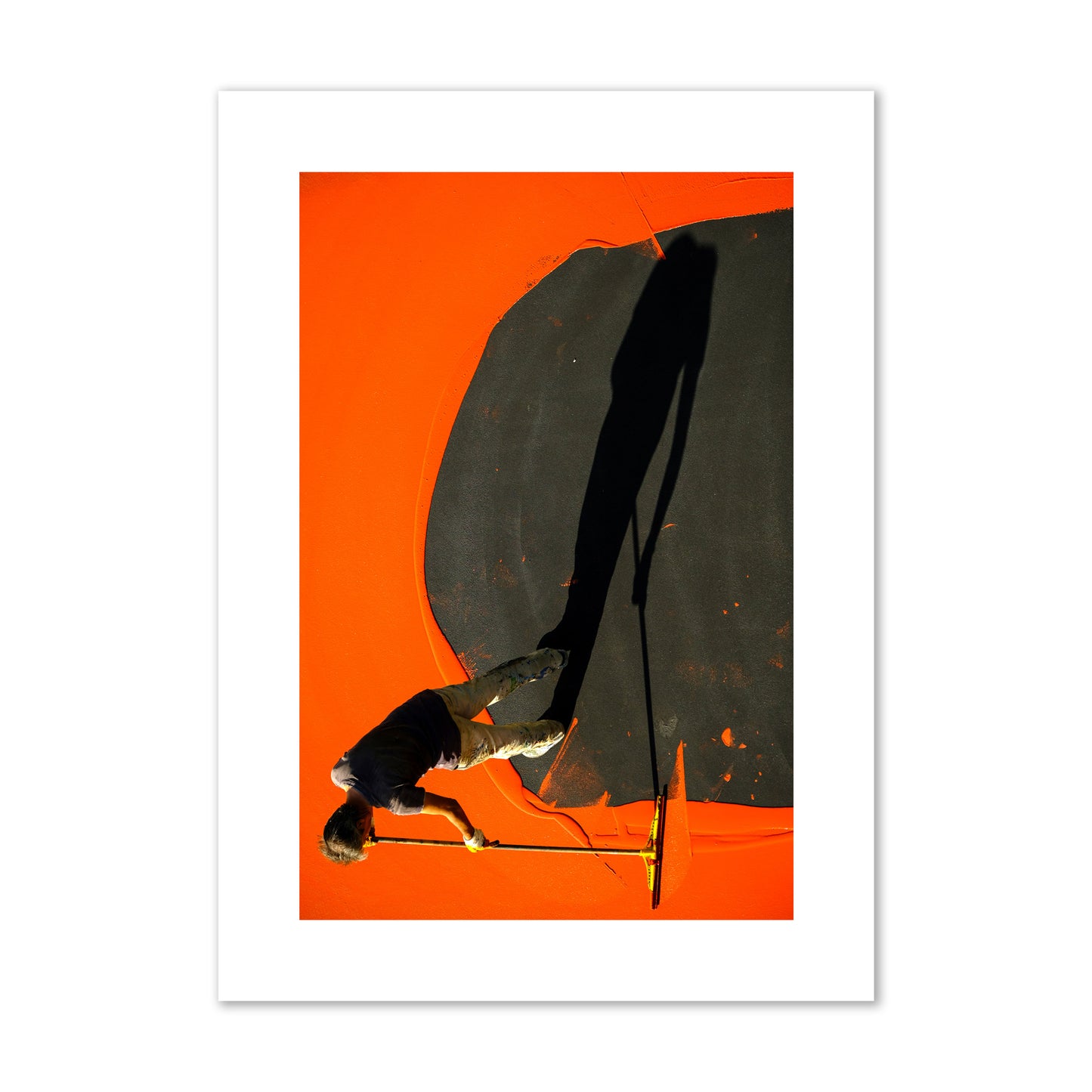 Fine art street photograph, overhead view of a man painting an orange rooftop, captured in vivid detail. Archival pigment print, large size, unframed.