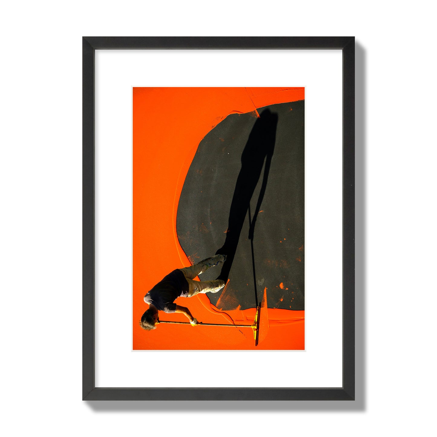 Fine art street photograph, overhead view of a man painting an orange rooftop, captured in vivid detail. Archival pigment print, medium size, black frame.