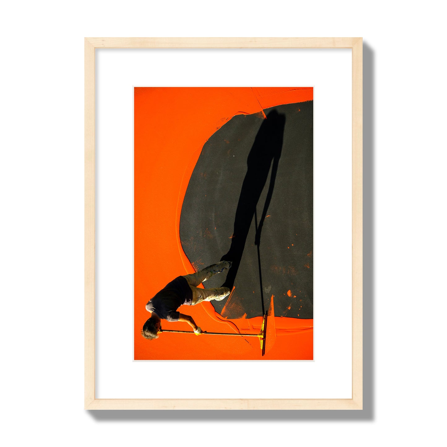 Fine art street photograph, overhead view of a man painting an orange rooftop, captured in vivid detail. Archival pigment print, medium size, natural wood frame.