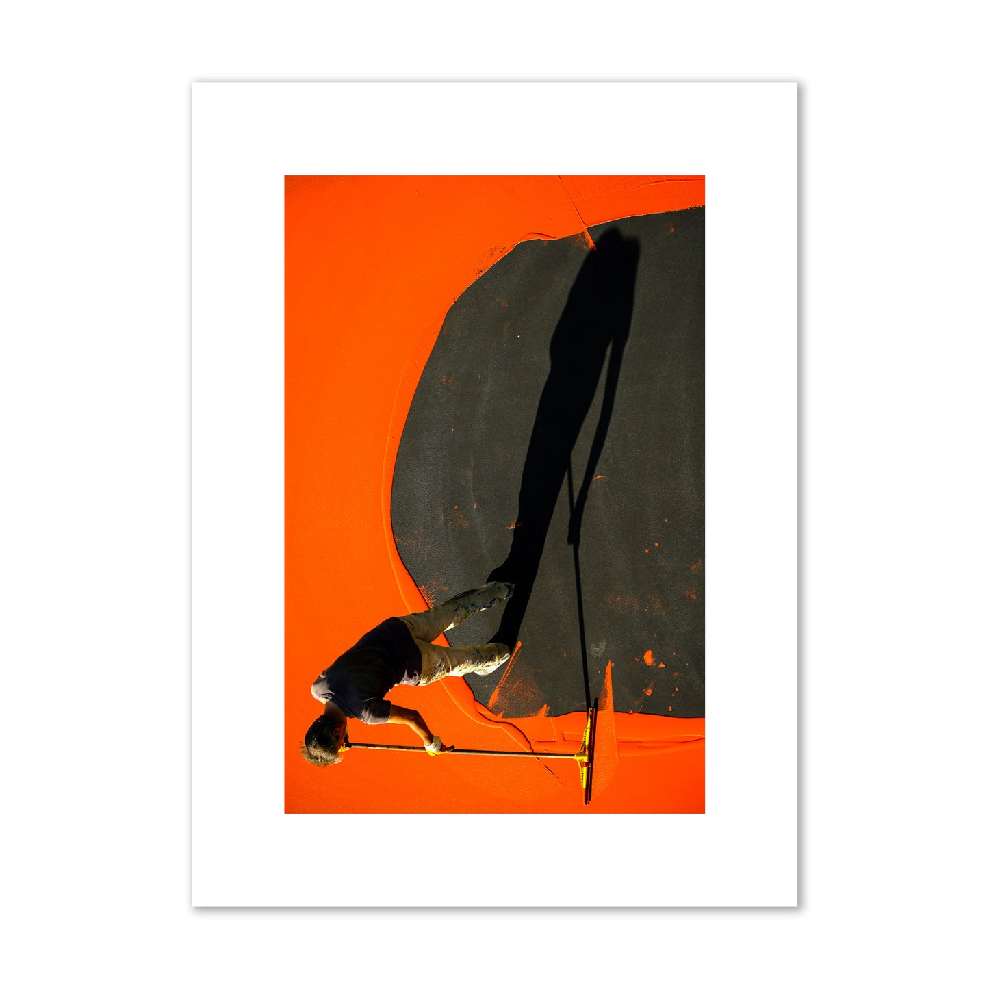 Fine art street photograph, overhead view of a man painting an orange rooftop, captured in vivid detail. Archival pigment print, medium size, unframed.