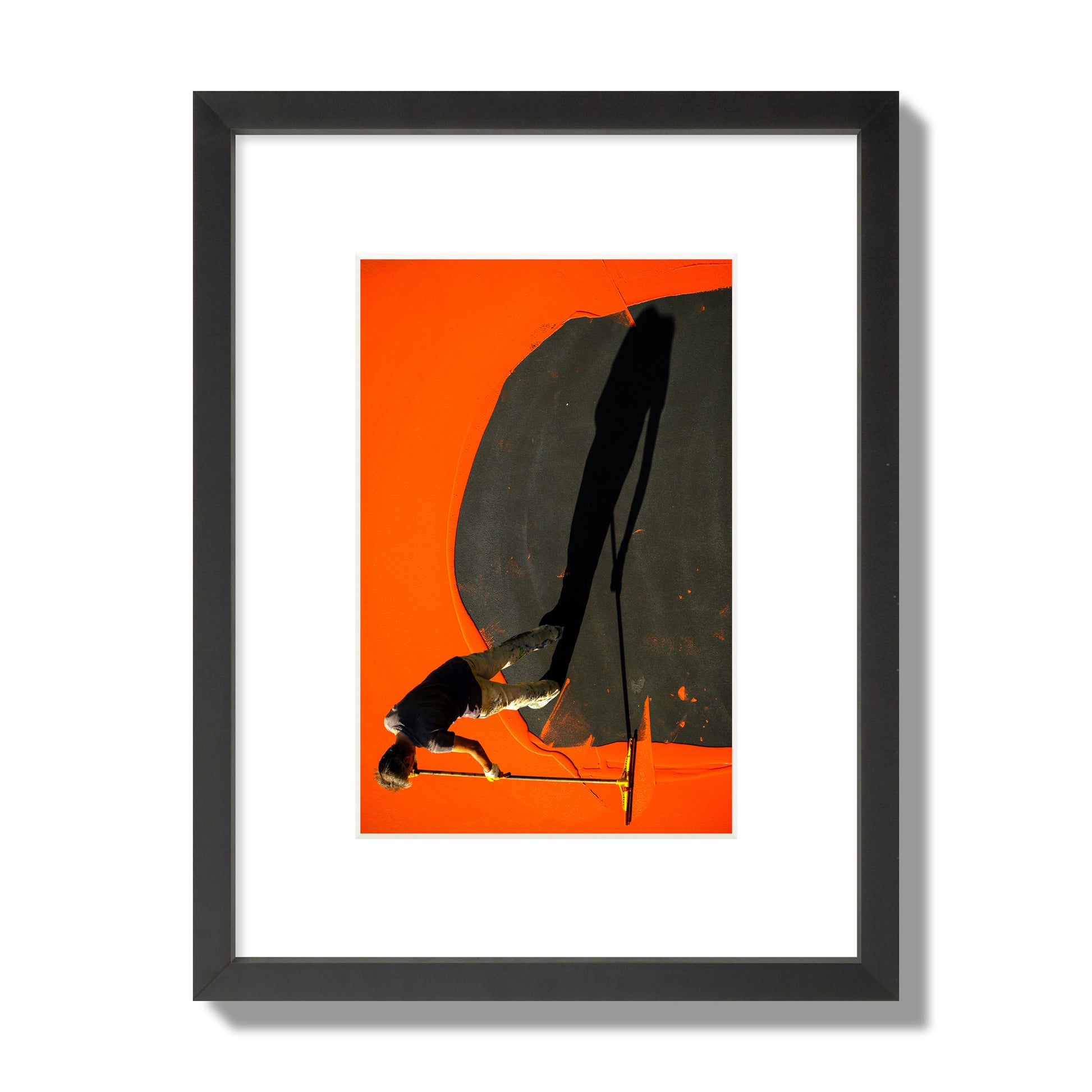 Fine art street photograph, overhead view of a man painting an orange rooftop, captured in vivid detail. Archival pigment print, small size, black frame.