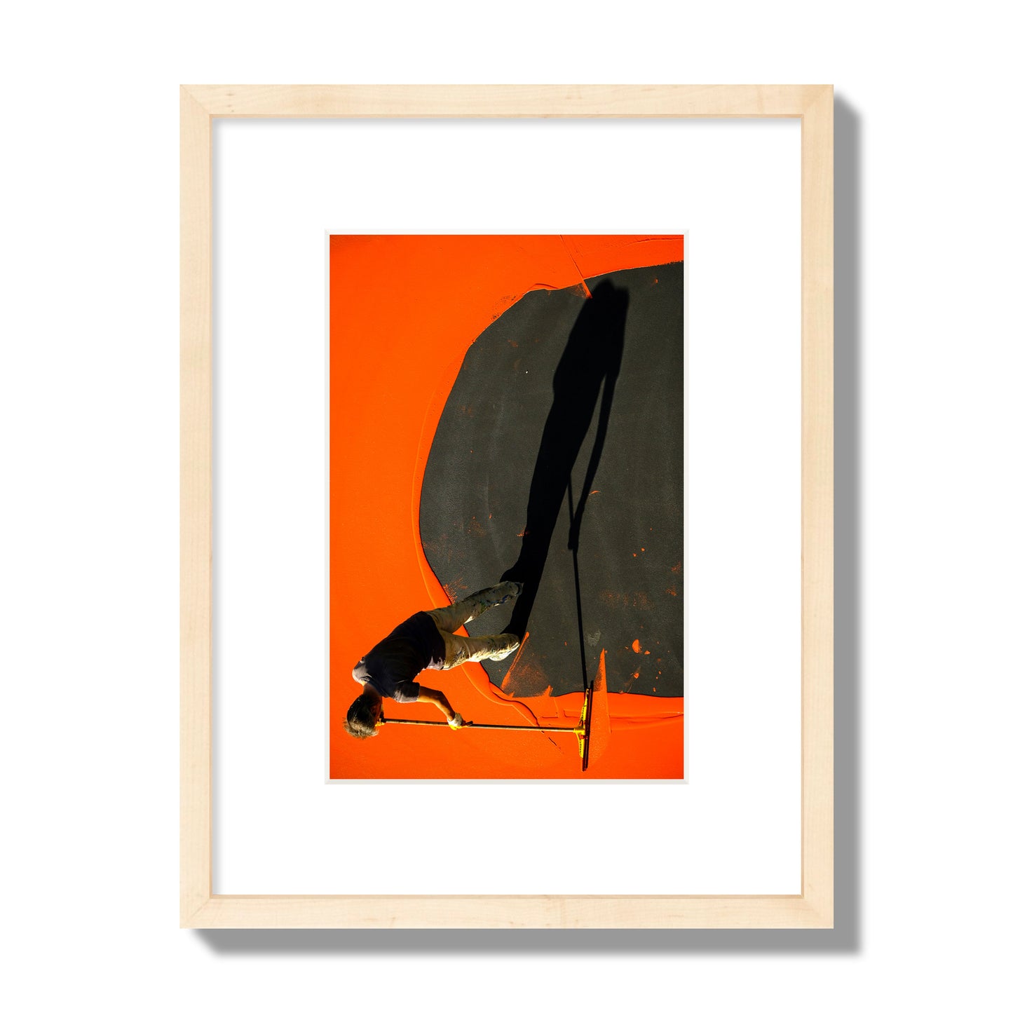 Fine art street photograph, overhead view of a man painting an orange rooftop, captured in vivid detail. Archival pigment print, small size, natural wood frame.