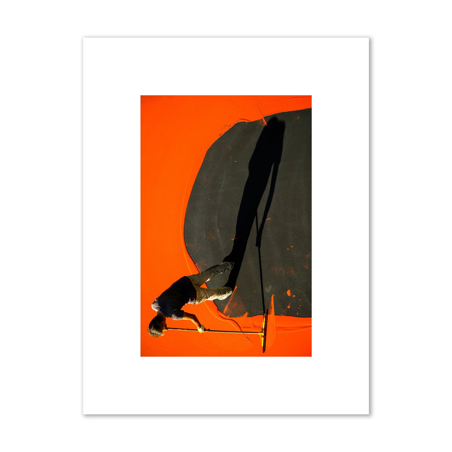Fine art street photograph, overhead view of a man painting an orange rooftop, captured in vivid detail. Archival pigment print, small size, unframed.