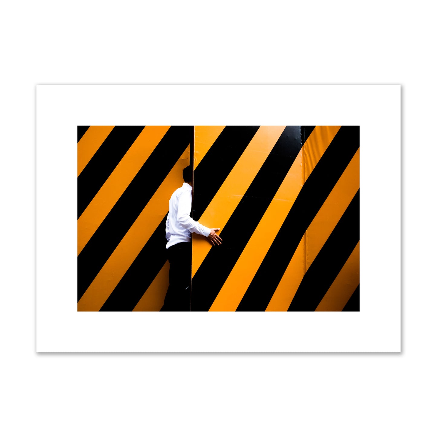Fine art street photograph of a man opening an orange and black stripped construction door. Archival pigment print, medium size, unframed.