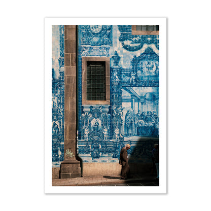 Fine art street photograph of an elderly man walking past traditional blue azulejo tile mural on a historic building in Lisbon, Portugal, archival pigment print, gallery size, print.
