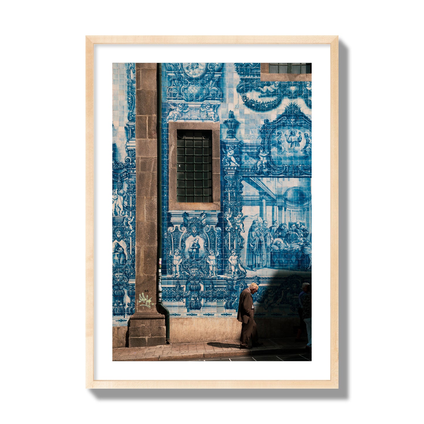 Fine art street photograph of an elderly man walking past traditional blue azulejo tile mural on a historic building in Lisbon, Portugal, archival pigment print, giant size, natural wood frame.