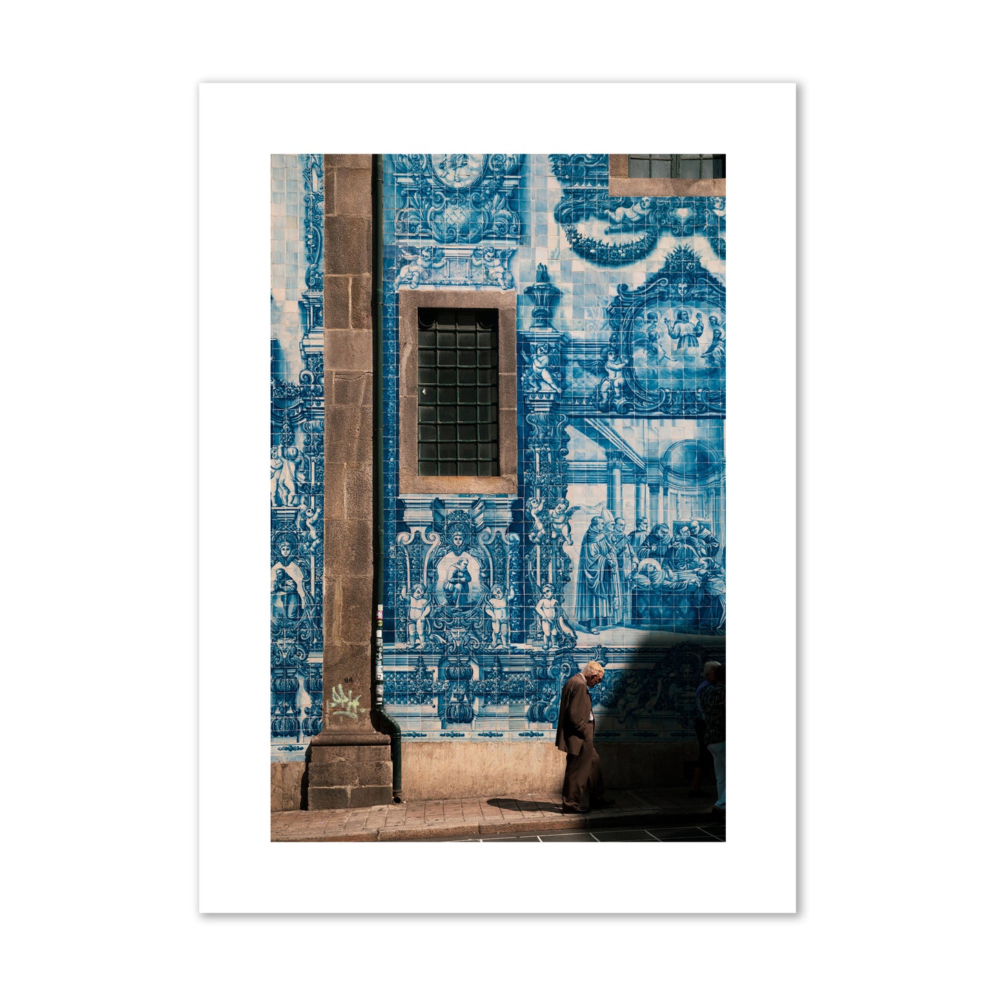 Fine art street photograph of an elderly man walking past traditional blue azulejo tile mural on a historic building in Lisbon, Portugal, archival pigment print, giant size, print.