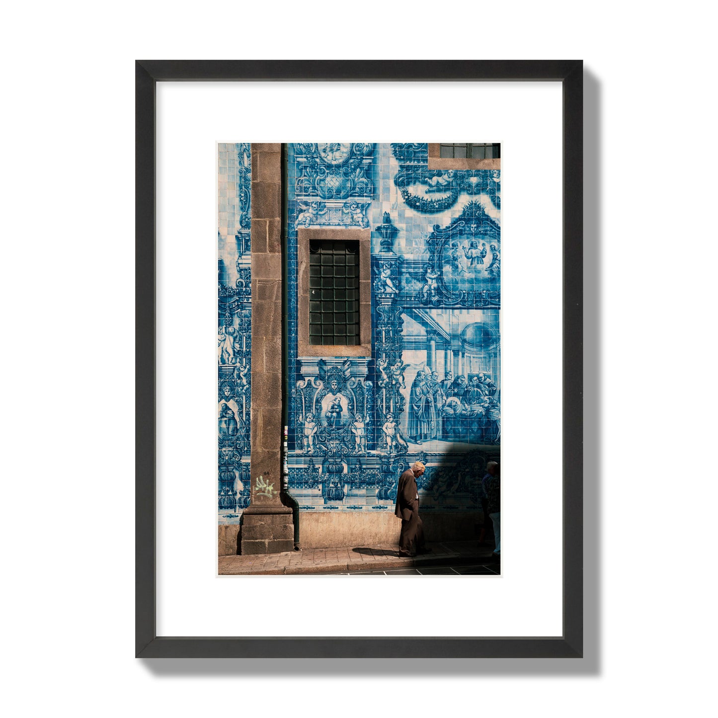 Fine art street photograph of an elderly man walking past traditional blue azulejo tile mural on a historic building in Lisbon, Portugal, archival pigment print, medium size, black frame.