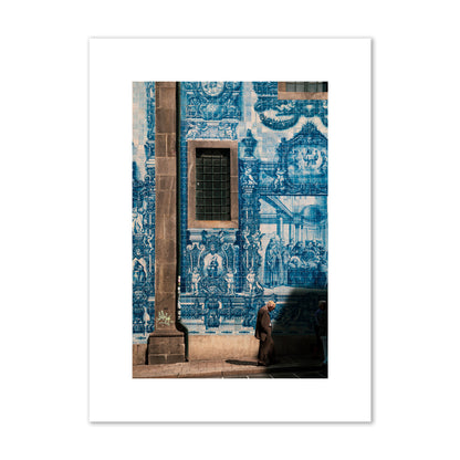 Fine art street photograph of an elderly man walking past traditional blue azulejo tile mural on a historic building in Lisbon, Portugal, archival pigment print, medium size, print.