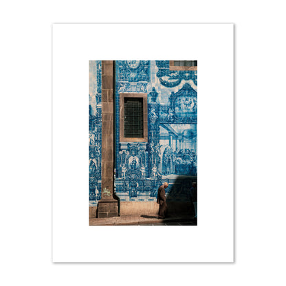 Fine art street photograph of an elderly man walking past traditional blue azulejo tile mural on a historic building in Lisbon, Portugal, archival pigment print, small size, print.