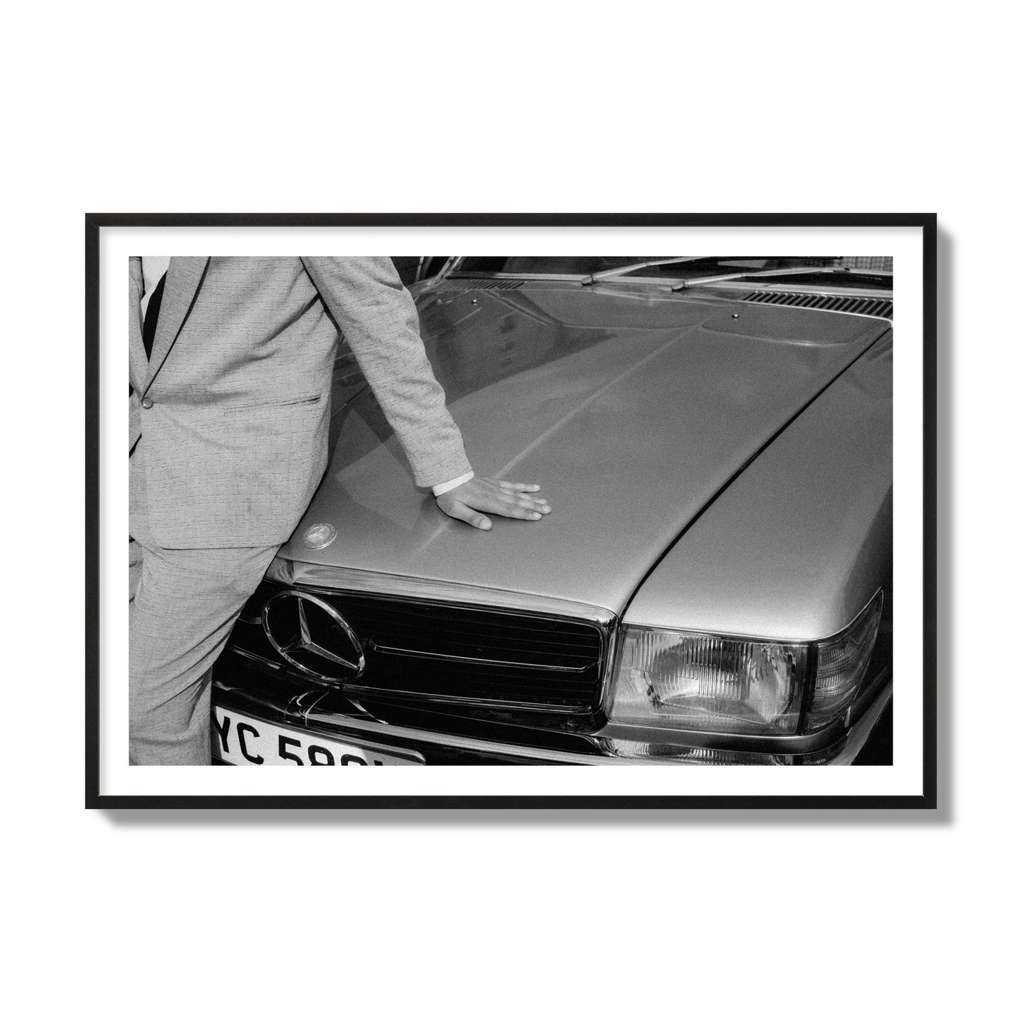 Fine art black & white photograph of a well dressed man leaning on a vintage Mercedes. Archival pigment print, collector size, black frame.