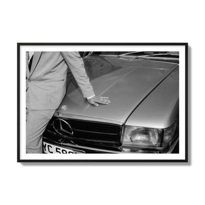 Fine art black & white photograph of a well dressed man leaning on a vintage Mercedes. Archival pigment print, collector size, black frame.