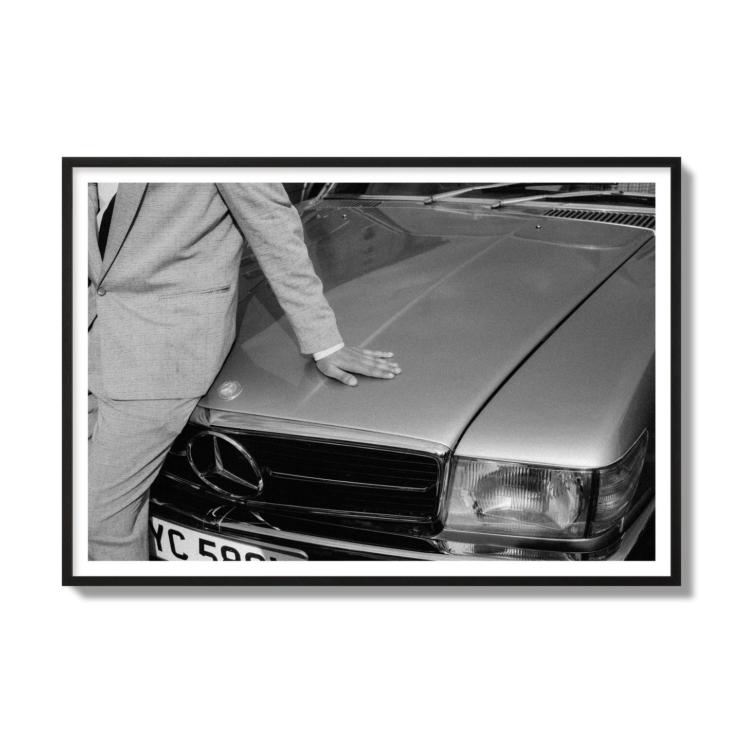 Fine art black & white photograph of a well dressed man leaning on a vintage Mercedes. Archival pigment print, gallery size, black frame.