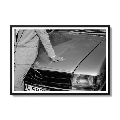 Fine art black & white photograph of a well dressed man leaning on a vintage Mercedes. Archival pigment print, gallery size, black frame.