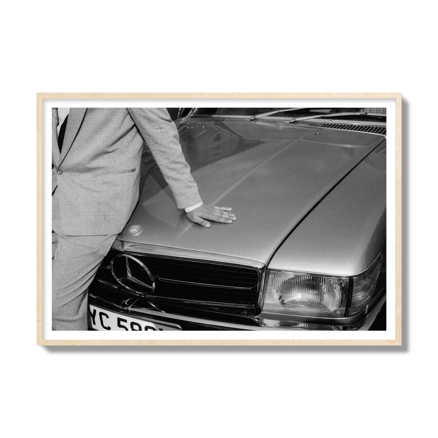 Fine art black & white photograph of a well dressed man leaning on a vintage Mercedes. Archival pigment print, gallery size, natural wood frame.