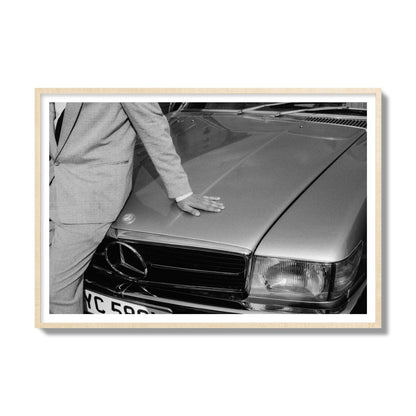 Fine art black & white photograph of a well dressed man leaning on a vintage Mercedes. Archival pigment print, gallery size, natural wood frame.