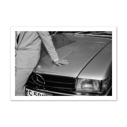 Fine art black & white photograph of a well dressed man leaning on a vintage Mercedes. Archival pigment print, gallery size, print.
