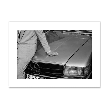 Fine art black & white photograph of a well dressed man leaning on a vintage Mercedes. Archival pigment print, large size, print.