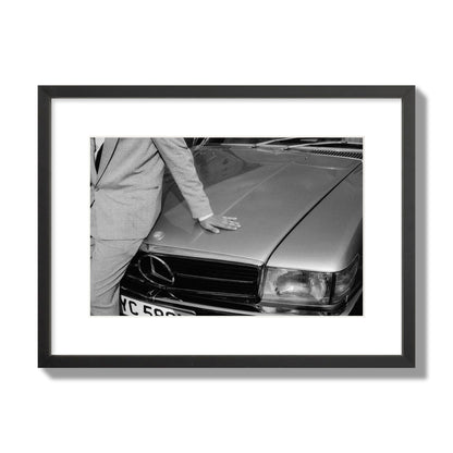Fine art black & white photograph of a well dressed man leaning on a vintage Mercedes. Archival pigment print, medium size, black frame.