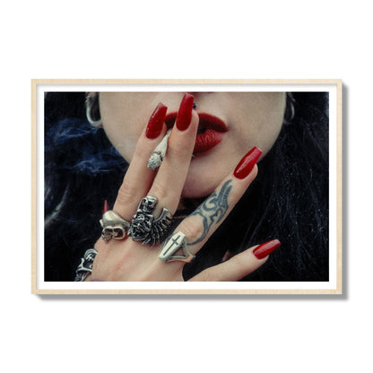 Fine art close-up photograph of a woman smoking, her hands covered with chunky rings and tattoos. Archival pigment print, gallery size, natural wood frame.