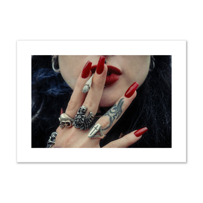 Fine art close-up photograph of a woman smoking, her hands covered with chunky rings and tattoos. Archival pigment print, giant size, print.