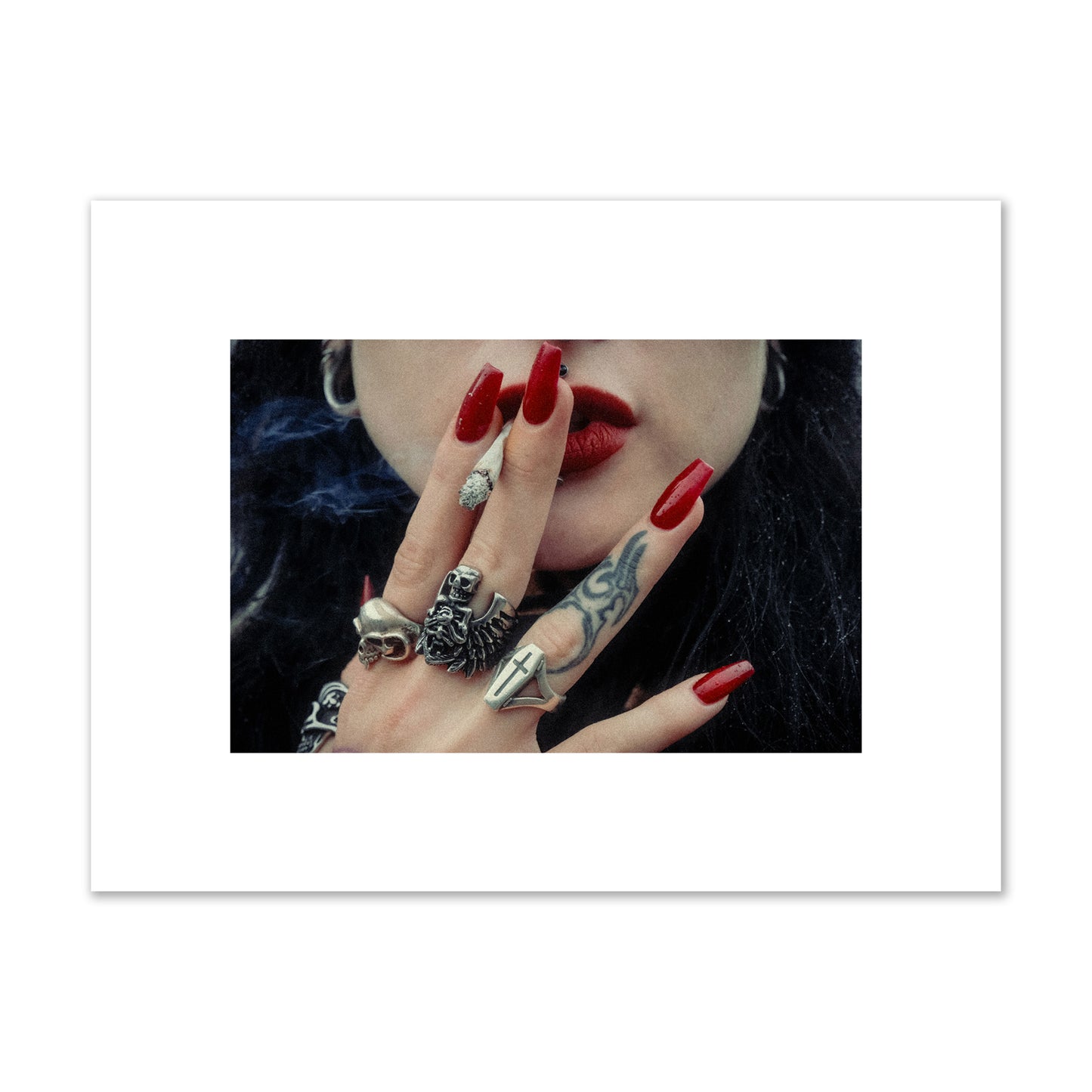 Fine art close-up photograph of a woman smoking, her hands covered with chunky rings and tattoos. Archival pigment print, small size, print.