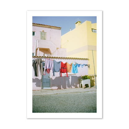 Fine art street photograph of a colorful outdoor scene in Portugal with clothes hanging on a line, archival pigment print, collector size, print.