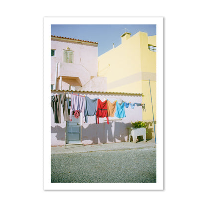 Fine art street photograph of a colorful outdoor scene in Portugal with clothes hanging on a line, archival pigment print, gallery size, print.